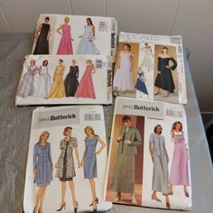 four different patterns of women's dresses on a table