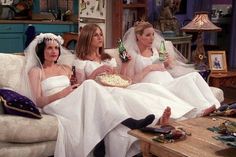 three brides sitting on a couch with one holding a bottle and the other drinking