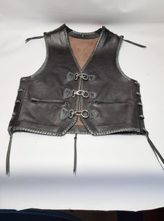 "This vest is suitable for anyone who wants to stand out from the crowd. Motorcyclists are excited and satisfied. Most of them are sewn with sequins from moto choirs. The vest is handmade from extremely high quality leather and has a beautiful braid at the edges. Completely comfortable and easy to carry. Inside, there are 2 large pockets on each side. They are very enthusiastic about our work. The most important thing for us is to satisfy our customers. If you have any questions about my product Fitted Winter Motorcycling Vest, Festival Biker Jacket, Punk Style Winter Vest For Biker Events, Punk Style Fitted Vest For Biker Events, Fitted Biker Jacket For Festivals, Black Fitted Moto Vest, Winter Leather Vest For Biker Events, Fitted Biker Vest For Biker Events, Fitted Punk Vest For Biker Events