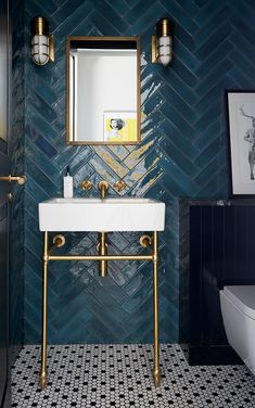 a white sink sitting under a mirror in a bathroom