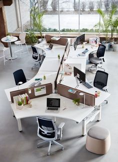 an office with multiple desks and chairs in it