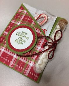 a christmas card with some candy in it and a bag on the table next to it