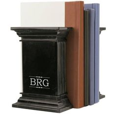 two books are stacked on top of each other in front of a black bookend