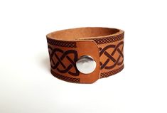 "Celtic Wolf Leather Cuff Bracelet This full grain cowhide leather bracelet is laser engraved with our original Celtic wolf design. The wolf is one of the most prevalent animals in the lore of many cultures. For the Celts the wolf was the companion and/or form many different gods and goddesses and was closely associated with the winter months the Gaelic word for January, \"Faoilleach\" translates to -month of the wolf. *To measure the right size for your wrist we recommend using a measuring tape Swords Design, Scotland National Flower, Raven Design, Celtic Raven, Celtic Wolf, Gaelic Words, Thistle Design, Crossed Swords, National Flower