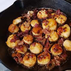 cooked scallops and bacon in a skillet on top of the stovetop