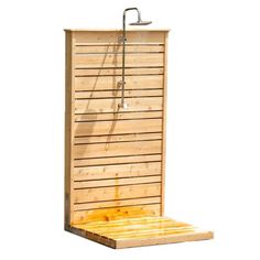 an outdoor shower with wooden slats on the sides and a metal faucet attached to it