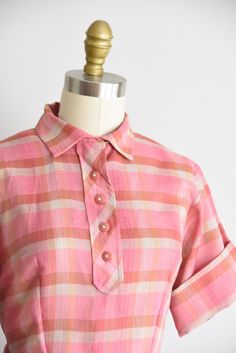 "Vintage 1950s shirtwaist daydress. Textured cotton in a red, pink, grey, and intermitted yellow plaid. Pointed collar, fold over sleeves, seamed waist and front button closure. Nipped waist with loops for belt, no belt. Free skirt. Vented back and decretive button back of nape. Side zip closure. State of garment | very good, light overall wear. Measurements ✂--- Best fit | Small Bust | up to 40 \" Shoulders | 15.5\" Shoulder to waist | 15 \" Sleeves | 8\" Waist | 26 \" Hips | free Total length Plaid Cotton Collared Shirt Dress, Plaid Collared Cotton Shirt Dress, 1950s Summer, Dior New Look, Lapel Dress, 1950s Women, Sangria Dress, Dress Up Day, Garden Dress