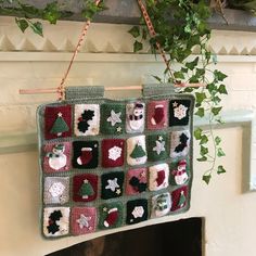 a crocheted christmas bag hanging from a fireplace