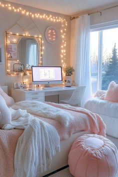 a bedroom decorated in pink and white with lights on the wall, bedding, pillows, desk and mirror