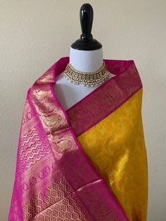 ShopNaya brings you the finest handloom silk from Kanchipuram, southern part of India, known for their highly skilled weavers and rich cultural heritage. Sunny yellow handloom pure silk saree. Body of the saree has peacock brocade design with 18in wide pink and gold zari border. Pallu has beautiful floral motifs with pink and gold zari. Blouse color is pink with the same zari border as the saree. ** Falls and pico finished. Blouse is cut and sent as a separate item. Silk mark tag attached. Wash Pure Chiffon Sarees, Indian Bride Outfits, Fancy Sarees Party Wear, Indian Saree Blouses Designs, Simple Sarees, Pink Bride, Saree Silk, Yellow Saree, Pure Chiffon