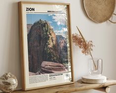 a wooden shelf topped with a poster and vase