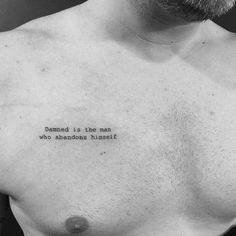 a man with a tattoo on his chest saying, demand is the man who abandons himself