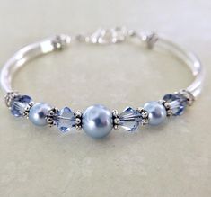 Blue wedding bracelet, pearl bridesmaid jewelry, blue crystal jewelry, something blue, wedding jewelry, bridesmaid gift, flower girl jewelry Elegant Blue Bangle As Gift, Elegant Bracelets For Bridesmaid Gift, Adjustable Jewelry For Bridesmaid Gift, Mother's Day, Adjustable Jewelry For Bridesmaid Gift On Mother's Day, Hypoallergenic Wedding Bangle Jewelry, Hypoallergenic Bangle Jewelry For Wedding, Adjustable Blue Pearl Bracelet For Wedding, Silver Pearl Bracelet For Bridesmaid Gift, Delicate Adjustable Bracelet For Bridesmaids