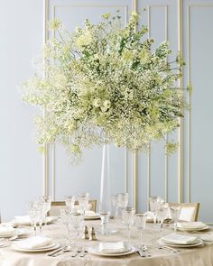 an image of a table setting with flowers in the center and place settings below it