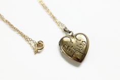 Vintage Heart Locket Necklace. This gold filled locket has decorative engravings and the letter P at the bottom. On the back, it is engraved with the date 8-19-5. Inside the locket contains one metal frame. The locket opens and closes easily and securely. The new gold filled chain was added by me, not vintage. Circa 1950's No hallmarks Measurements- Chain is 18 inches in length Locket is about 1 inch length Very good condition. Minor wear due to age and use. Brass Heart Pendant Wedding Jewelry, Brass Heart Pendant Jewelry For Wedding, 14k Stamped Pendant Locket Necklace For Wedding, Gold Etched Locket Necklace For Keepsake, Antique Gold Filigree Necklaces For Anniversary, Antique Gold Filigree Necklace For Anniversary, Vintage Yellow Gold Locket Necklace For Keepsake, Antique Hallmarked Locket Necklace For Anniversary, Stamped 14k Gold Medallion Locket Necklace For Anniversary