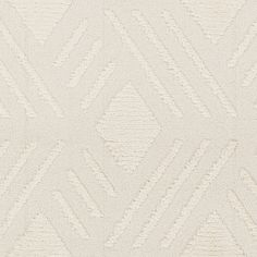 an upholstered white rug with diamond shapes on it