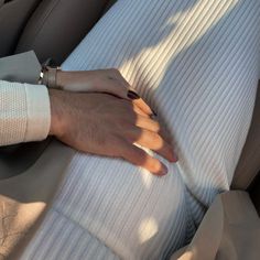 a person's hand resting on the back of a car seat