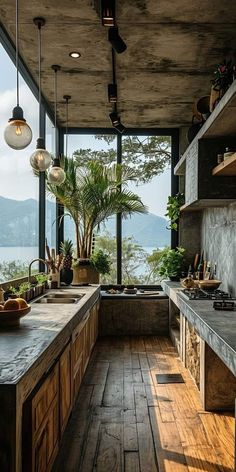 an open kitchen with wooden floors and large windows overlooking the water is pictured in this image