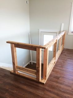 an empty room with wood floors and white walls