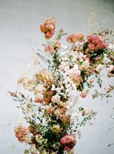 a vase filled with lots of pink and white flowers