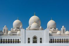 a large white building with many domes on top