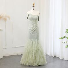 Upgrade your wedding party look with our Sparkly Sage Green Mermaid Evening Dress. The shimmering fabric and mermaid silhouette will make you stand out while the sage green color adds a touch of elegance. Perfect for formal events, this dress is sure to make you feel like a true mermaid. window.adminAccountId=244214477; Floor-length Tulle Mermaid Dress For Banquet, Tulle Mermaid Hem Wedding Gown, Mermaid Hem Tulle Wedding Gown, Wedding Tulle Gown With Mermaid Hem, Tulle Mermaid Hem Evening Dress For Wedding, Green Mermaid Dress With Fitted Bodice, Green Fishtail Mermaid Dress With Fitted Bodice, Floor-length Green Bridesmaid Dress For Banquet, Green Floor-length Bridesmaid Dress For Banquet