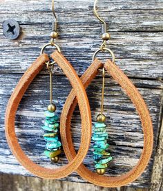 A beautiful drop of natural Turquoise dangles inside these large, handmade Latigo leather earrings. Turquoise stones are matched by hand to compliment each other in size, shape, and color, making this a striking and unique pair. (These stones are genuine Turquoise, not dyed magnesite or howlite.) Personalize your earrings with the following leather color options: black, mahogany, tan, beige, white, and silver. Earwires, jump rings, and posts are nickel-free and come in either antique brass or si Leather And Turquoise Earrings, Leather Strip Earrings, Leather Beaded Earrings, Leather Earrings Ideas, Handmade Leather Jewelry, Leather Jewelry Diy, Diy Leather Earrings, Leather Supplies, Turquoise Drop Earrings