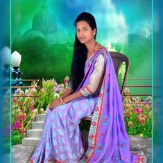 a woman sitting on top of a chair wearing a purple and blue sari dress