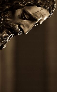 a black and white photo of a statue of jesus with his head tilted to the side