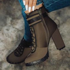 a woman's legs with white nails and brown boots