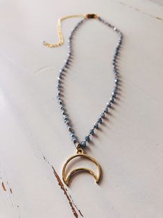 "A stunning piece from our new minimalist collection (see last pic, other jewelry sold separately). Soft blue beaded rosary chain with gold toned brassy accents and a matching geometric shaped gold crescent moon charm. One necklace per purchase. Length: 14\" rosary with a 3.5\" adjustable chain" Gold Jewelry With Moon Charm And Round Beads, Gold Necklaces With Moon Charm And Round Beads, Dainty Moon-shaped Handmade Necklace, Gold Crescent Wire Wrapped Necklaces, Blue Jewelry With Moon Charm And Round Beads, Handmade Blue Moon Necklaces, Minimalist Crescent Brass Necklaces, Blue Celestial Necklace With Moon Charm, Handmade Blue Moon-shaped Necklaces