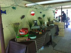 there are many items on the table in this room that is decorated with fish net