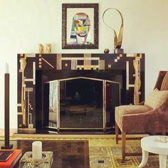 a living room with a fire place and art work on the fireplace mantels