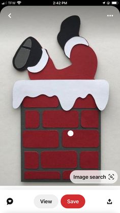 an image of santa stuck in a chimney made out of cardboard and cut into paper