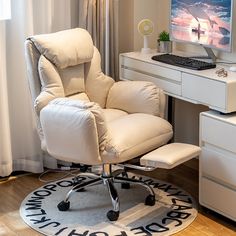 a white chair sitting in front of a computer desk