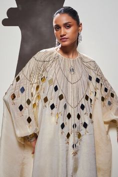 Ivory cape shirt embellished with mirror work adornments. Comes with solid straight pant. - Aza Fashions Embellished Tops For Eid Reception, Festive Kaftan With Mirror Work And Cape Sleeves, Festive Mirror Work Kaftan With Cape Sleeves, White Mirror Work Kaftan For Festive Occasions, White Kaftan With Mirror Work For Eid, Eid Kaftan With Mirror Work And Cape Sleeves, White Tops With Dupatta For Festive Occasions, Elegant Gota Work Blouse For Eid, Festive White Embellished Kurta