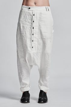 "Off-White Drop Crotch Boiled Linen Trousers with Buttons__ // EXPRESS DELIVERY ONLY __Semi Visible Front Closure with Black Buttons __3 Front & 2 Back Pockets __Fully Completed Bound Seams __Elastic Backside Waistband model__ bust 92 (36\"), waist 72 (28\"), hips 102 (40\"), biceps 28 (11''), height 177 (5'8\"), kg 65 (143 lbs) model wears size M | color: off-white fabric__ 100 linen care__ dry cleaning do not bleach do not tumble dry do not iron to keep wrinkle effect sizing__ size XS (US White Harem Pants With Pockets And Loose Fit, Fitted White Harem Pants With Pockets, White Cotton Tapered Leg Harem Pants, White Relaxed Fit Harem Pants With Straight Leg, White Cotton Harem Pants With Pockets, White Cotton Straight Leg Harem Pants, White Harem Pants With Pockets, White Straight Leg Harem Pants With Pockets, White Cotton Parachute Pants With Belt Loops