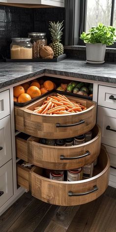 an open drawer in the middle of a kitchen with fruits and vegetables on it's sides