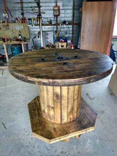 a round table made out of wood in a garage