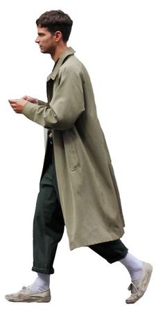 a man walking down the street in an overcoat