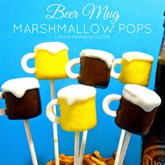 beer mug marshmallow pops are sitting on top of some pretzel sticks