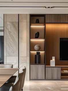 an elegant dining room with marble walls and wooden furniture, along with a large flat screen tv mounted on the wall