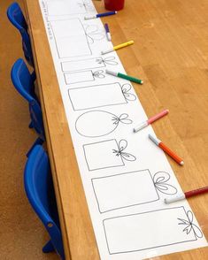 a wooden table topped with lots of writing paper