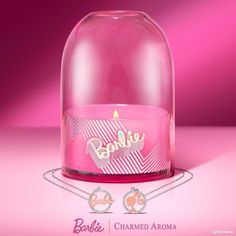 a pink candle with the word barbie on it