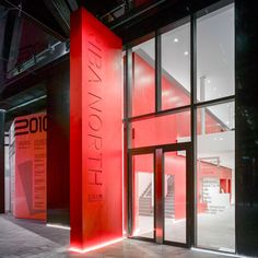 the entrance to an art gallery with red walls and glass doors that read, i love new york