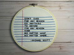 a cross stitch quote on a wooden wall