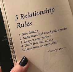 a person holding an open book with the title 5 relationship rules written on it, in front of them