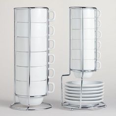 a stack of white plates sitting next to each other on top of a metal stand