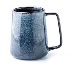 a blue mug sitting on top of a white table