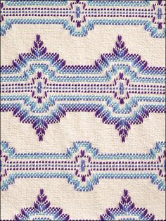 a blue and white quilt with an intricate design on it's border, in the middle